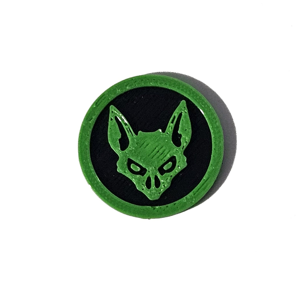 Green and black bat face Halloween token on pure white background