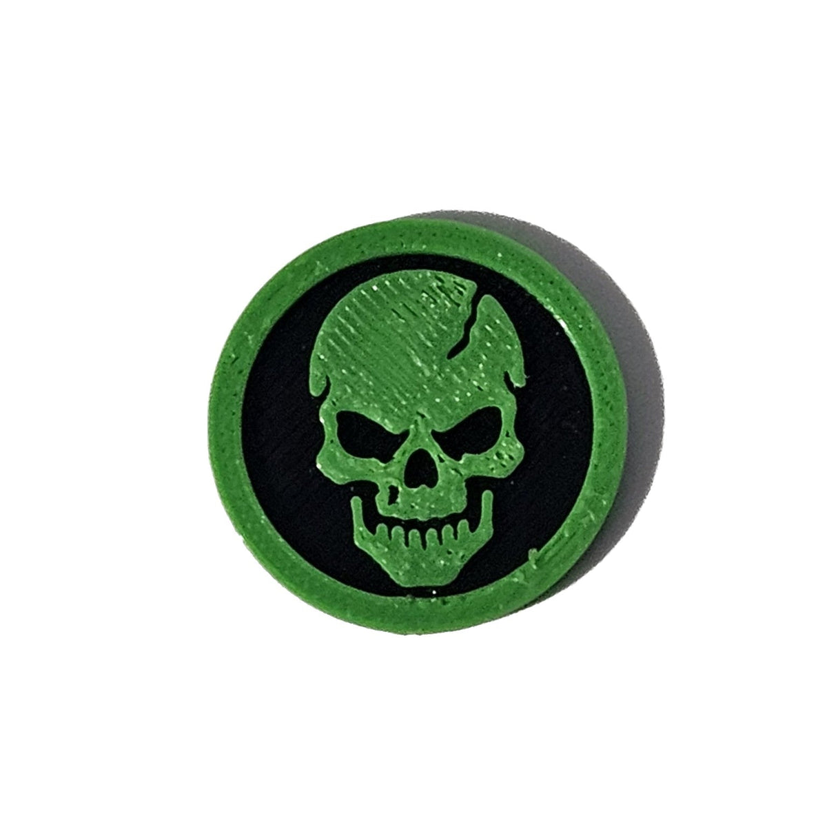 Green and black skull face Halloween token on pure white background