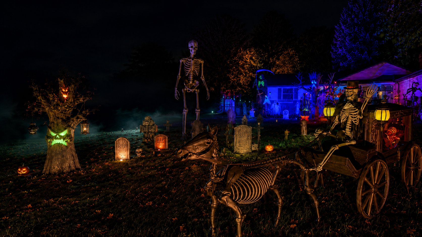 HalloweenParts.com yard display with 12 foot skeleton, skeletal horse and carriage, graveyard props and Halloween decorations