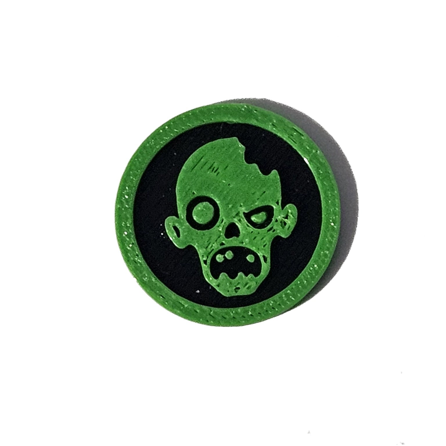 Green and black zombie face Halloween token on pure white background